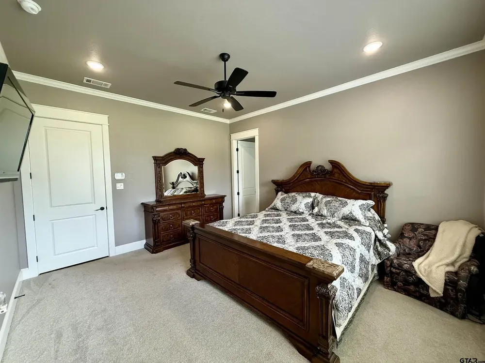 Primary bedroom suite set apart from the guest rooms at 644 An County Road 3009 on Lake Palestine in Frankston TX