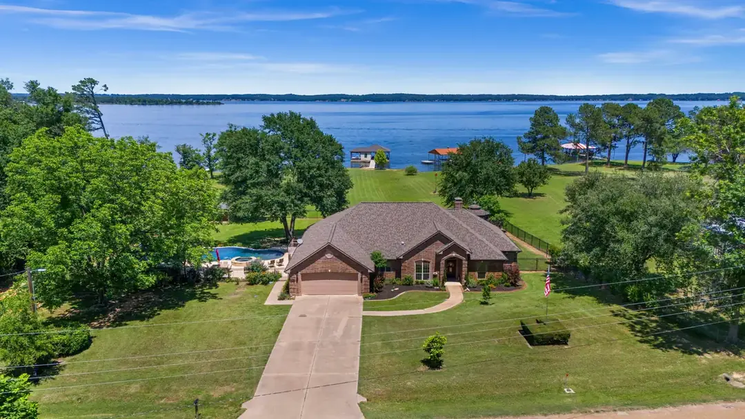 Aerial view of a Sunrise Shores waterfront home on Lake Palestine at sunset