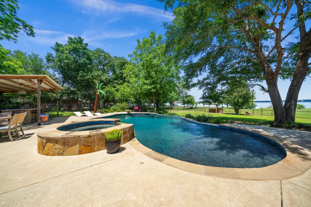 New gunite pool hot tub and covered outdoor kitchen with Lake Palestine water views at Sunrise Shores Chandler TX for sale